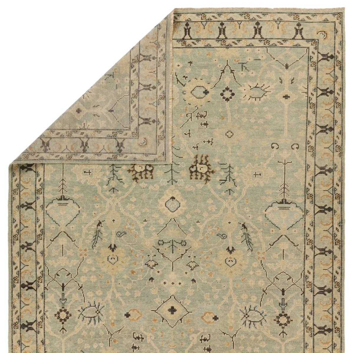 Featuring Rhapsody Markid Hand-Knotted Rug by Jaipur Living at Amethyst Home. The Rhapsody Markid features heirloom-quality designs of stunningly abrashed Old World patterns. The Markid area rug boasts a beautifully distressed floral and Oushak motif with a decorative border. The light blue and tan tones are accented with black and beige hues for added dept. Amethyst Home provides interior design, new home construction design consulting, vintage area rugs, and lighting in the Charlotte metro area.