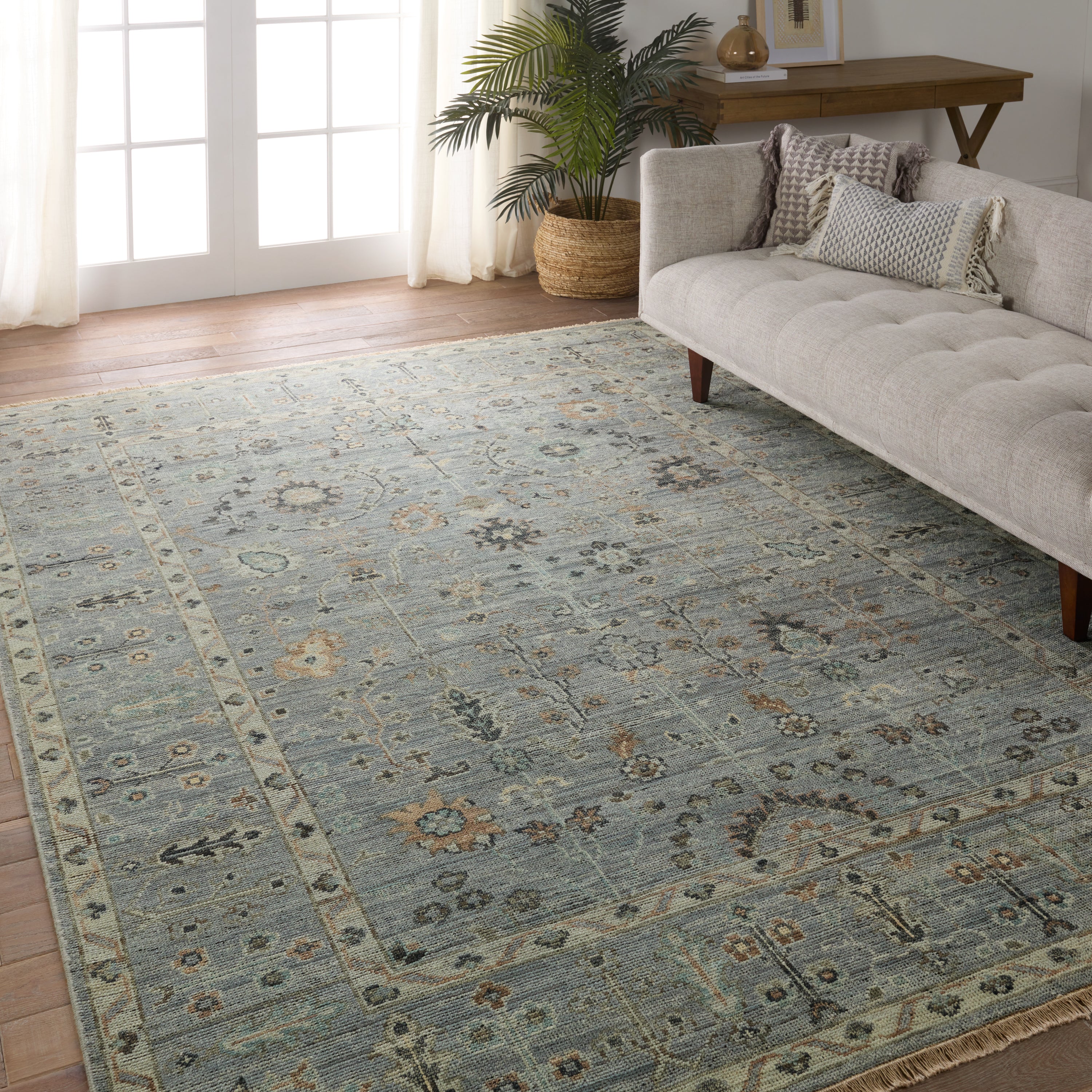 Featuring Rhapsody Nysa Hand-Knotted Rug by Jaipur Living at Amethyst Home. The Rhapsody collection features heirloom-quality designs of stunningly abrashed Old World patterns. The Nysa area rug boasts a beautifully washed floral motif with a decorative border. The blue tone is accented with rich green, tan, navy, and cream hues for added depth and intrigue. This durable wool handkn. Amethyst Home provides interior design, new construction, custom furniture, and area rugs in the Austin metro area.