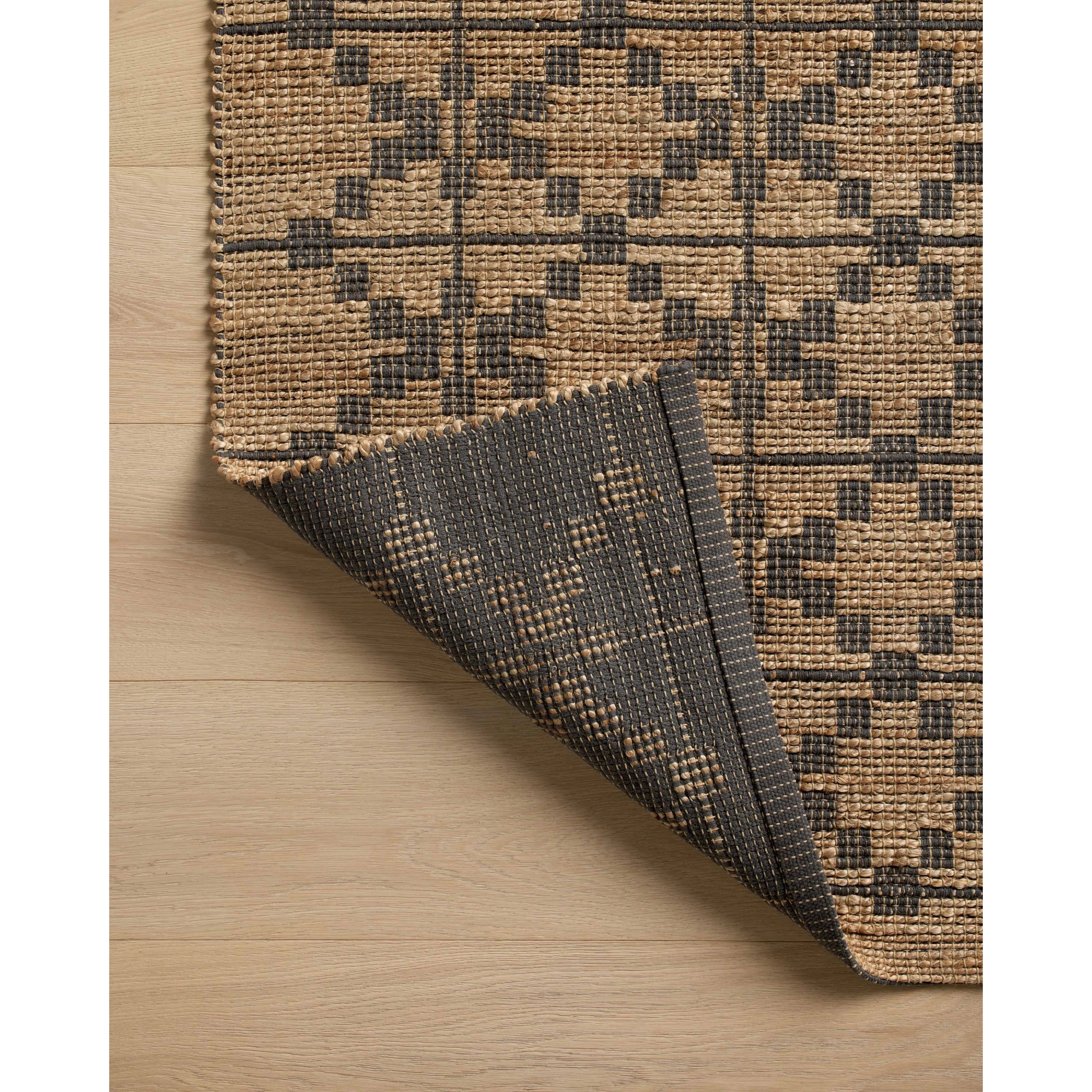 Featuring Chris Loves Julia x Loloi Judy Natural / Graphite Rug by Loloi at Amethyst Home. Hand Woven76% Jute l 24% CottonJUD-05 Natural / GraphitePile Height: 0.5". Amethyst Home provides interior design, new home construction design consulting, vintage area rugs, and lighting in the Tampa metro area.