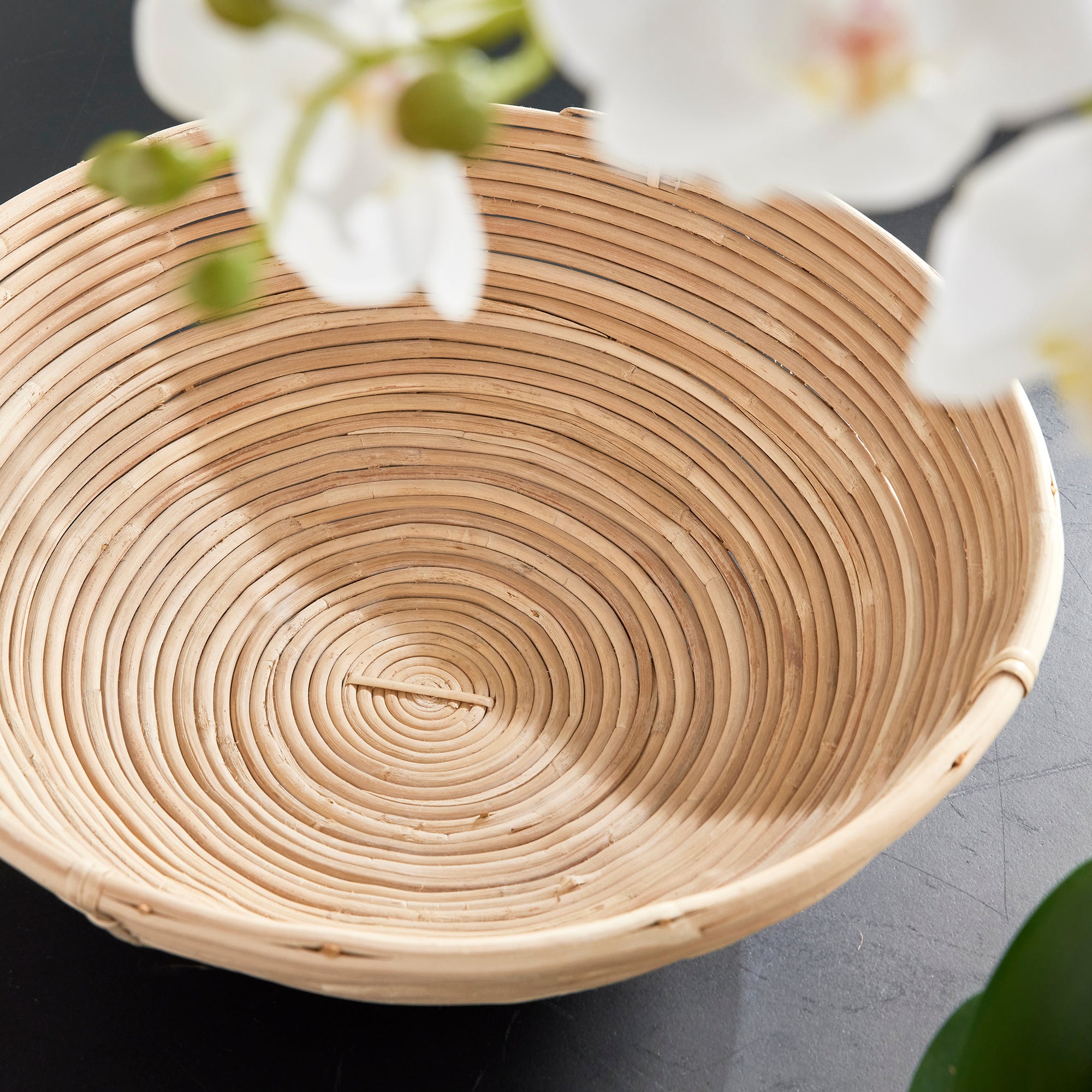 This oversized low bowl cane rattan set of two are stacked, not woven creating a more substantial basket. With a light and refined look, cane rattan is at home in the modern to transitional space. Amethyst Home provides interior design, new construction, custom furniture, and area rugs in the Alpharetta metro area.