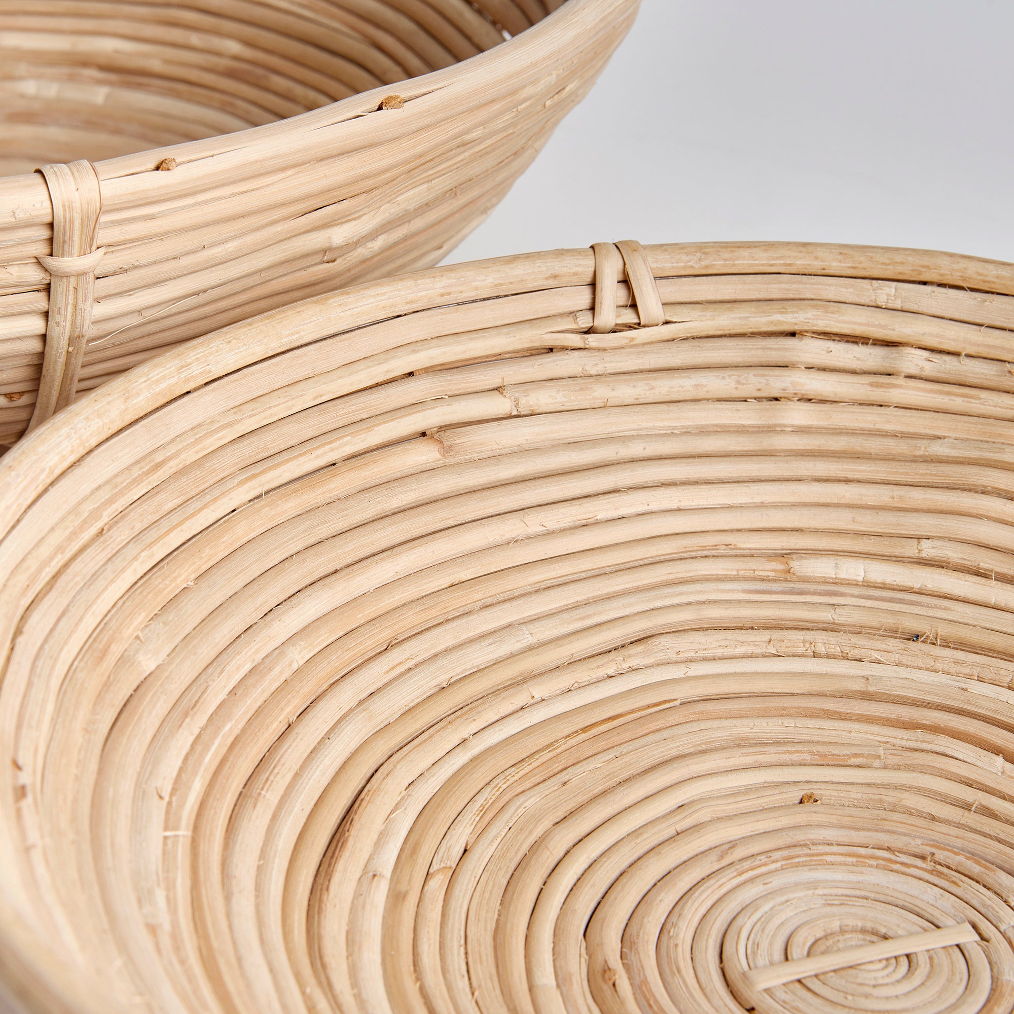 This oversized low bowl cane rattan set of two are stacked, not woven creating a more substantial basket. With a light and refined look, cane rattan is at home in the modern to transitional space. Amethyst Home provides interior design, new construction, custom furniture, and area rugs in the Nashville metro area.