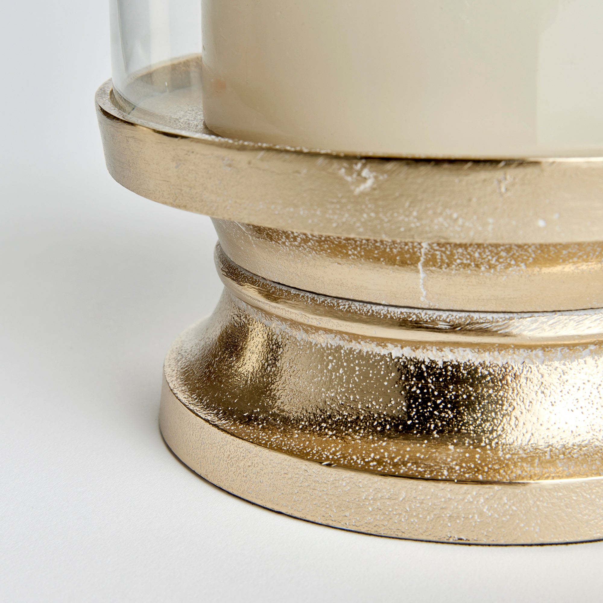 With a traditional silhouette and a snow-on-brass finish, this footed hurricane is at home in the fresh traditional setting. Add a tall pillar candle and enjoy the warm glow. Amethyst Home provides interior design, new construction, custom furniture, and area rugs in the Kansas City metro area.