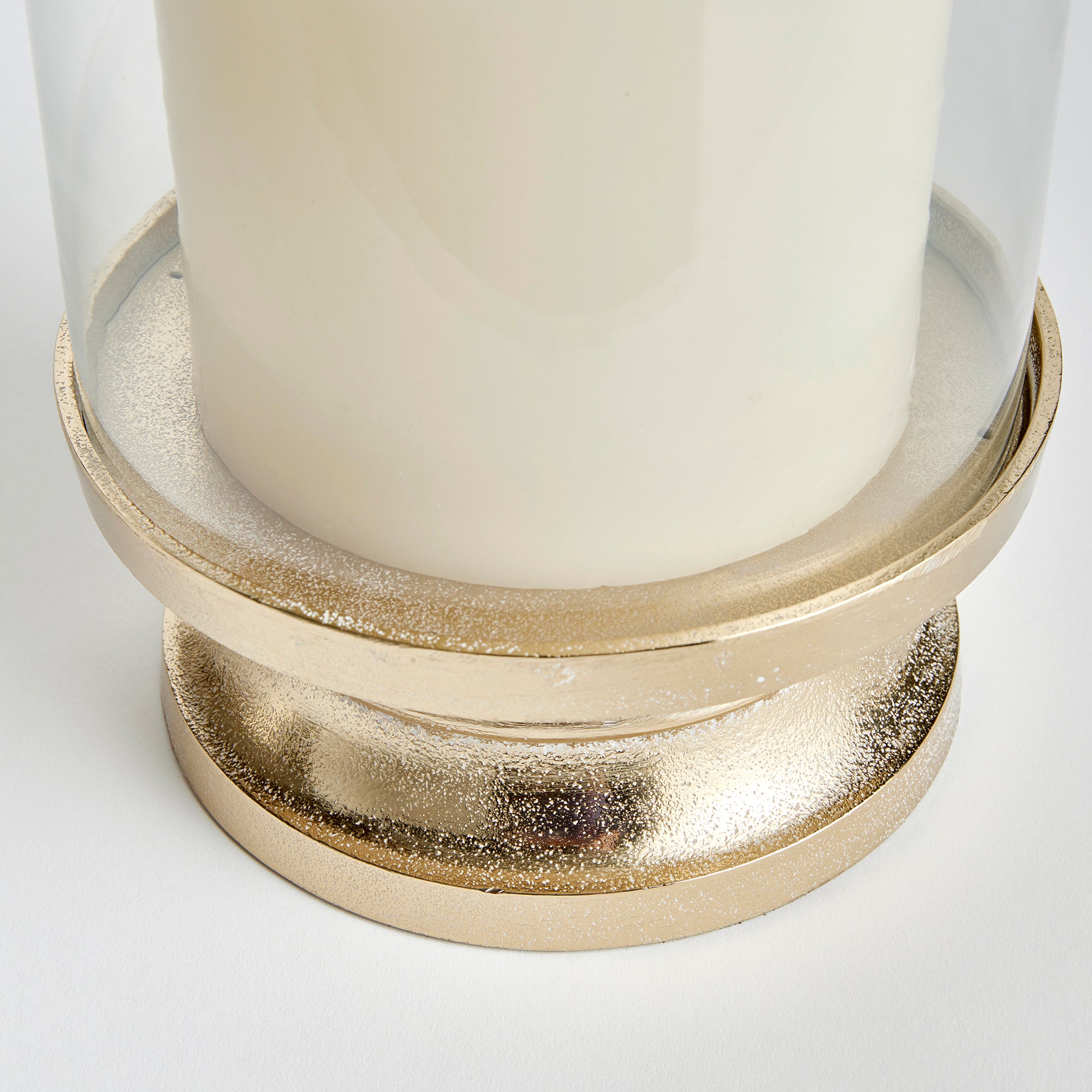 With a traditional silhouette and a snow-on-brass finish, this footed hurricane is at home in the fresh traditional setting. Add a tall pillar candle and enjoy the warm glow. Amethyst Home provides interior design, new construction, custom furniture, and area rugs in the Omaha metro area.