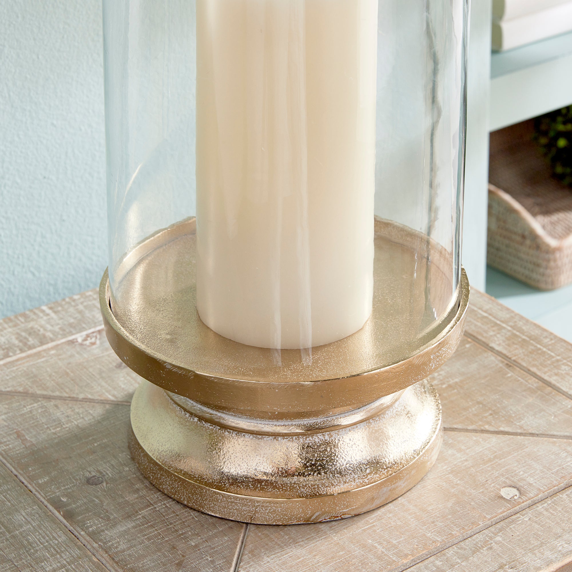 With a traditional silhouette and a snow-on-brass finish, this footed hurricane is at home in the fresh traditional setting. Add a tall pillar candle and enjoy the warm glow. Amethyst Home provides interior design, new construction, custom furniture, and area rugs in the Salt Lake City metro area.