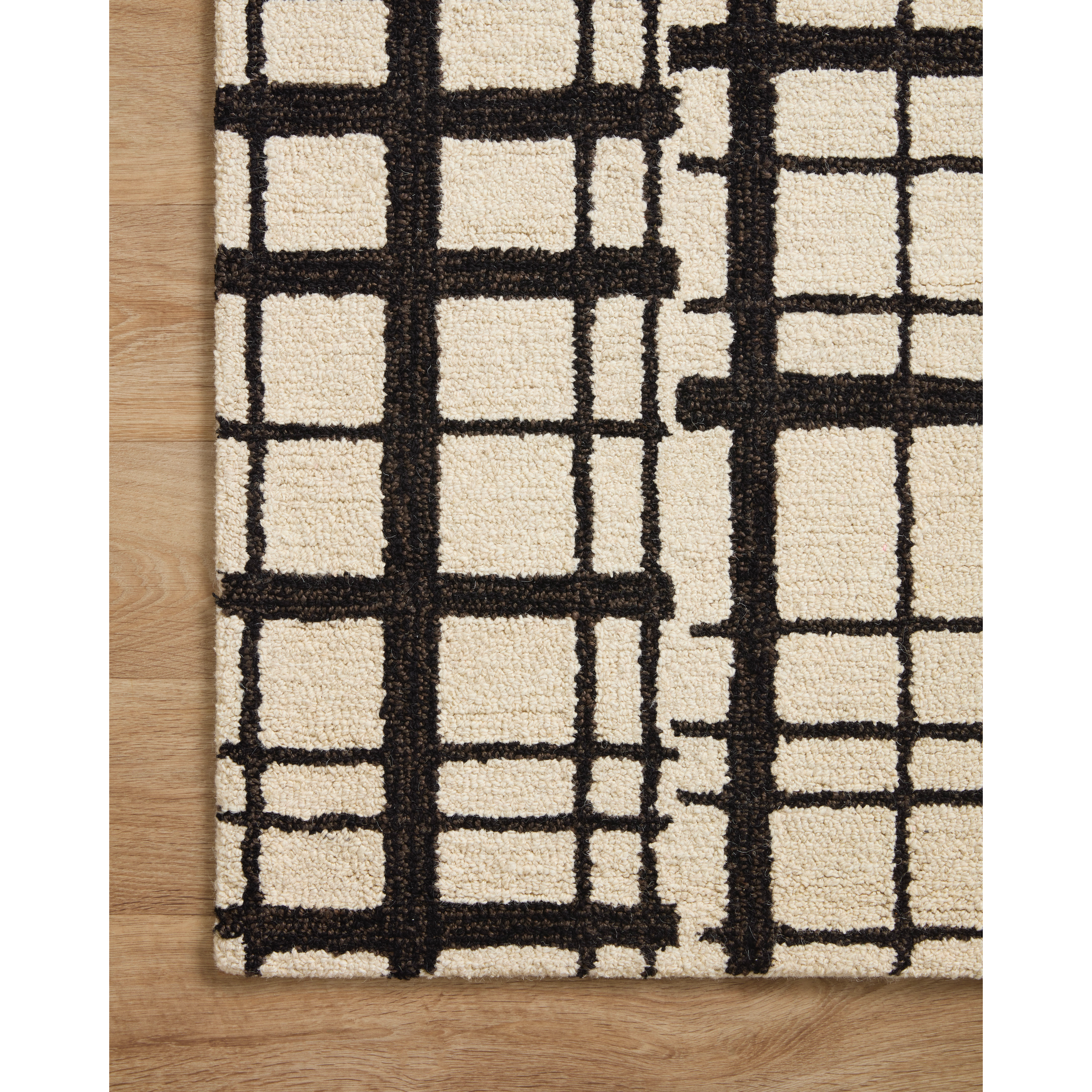 Featuring Polly Chris Loves Julia x Loloi Black / Ivory Rug by Loloi at Amethyst Home. Hand-tufted of wool and jute pile, the Polly Black / Ivory rug for Chris Loves Julia x Loloi brings a fresh take on modern yet classic designs. With striking gridded designs toned down by a neutral color palette, Polly is a timeless choice for any room. Polly is also GoodWeave certified, ensuring. Amethyst Home provides interior design, new construction, custom furniture, and rugs for the Winter Park metro area.