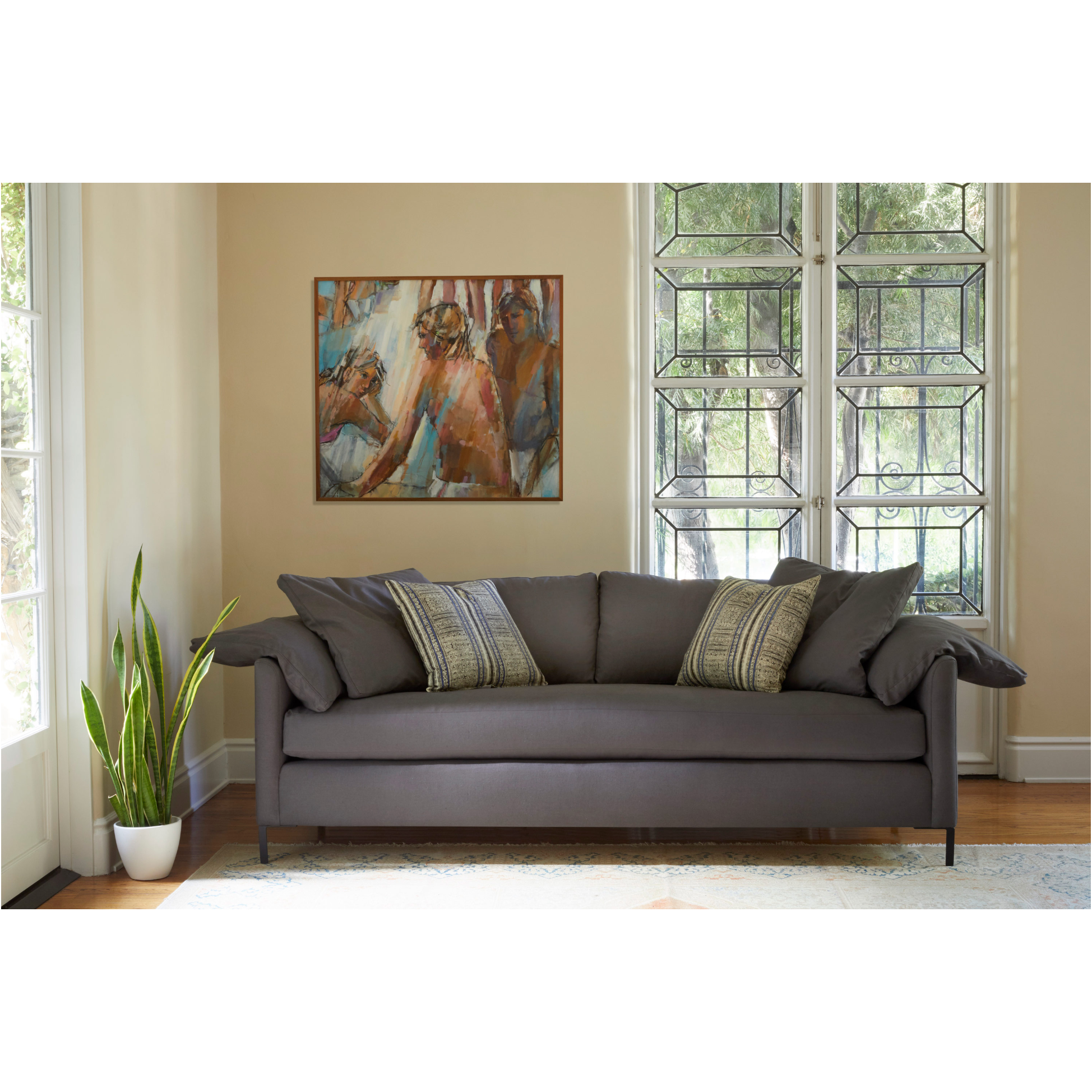 Featuring Radley Upholstered Sofa Family by Cisco Brothers at Amethyst Home. A love letter to the Radley sofa -- the metal iron feet and laid back approach to sitting is effortlessly chic. A feather cloud cushion with down filled back cushions allow for a sit that is upright yet comfortably deep. Photographed in Molino Fog. Lifestyle Photograph in Grayson. Amethyst Home provides interior design, new home construction design consulting, vintage area rugs, and lighting in the Park City metro area.