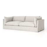 Featuring Habitat Sofa - Valley Nimbus by Four Hands at Amethyst Home. Loungey and slipcovered, the Habitat sofa is made for modern living. Shelter arms and pillow-inspired cushions are covered in comfortable, durable, and stain-resistant performance fabric. The thread within the fabric itself is doused in a material meant to prevent it from becoming stained.  Amethyst Home provides interior design, new home construction design consulting, vintage area rugs, and lighting in the Houston metro area.