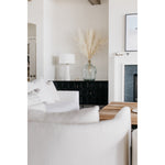 A piece we lovingly refer to as the "three legged-dog" to our clients, the Sullivan chair from Verellen is a beautiful statement piece from every angle. The 360 degree attention to detail makes it a striking piece in open concept spaces. This chair sits wonderfully for mounted televisions or with conversation and a glass of wine in the evening.  Select from Ash wood or Walnut legs.  33”w X 34”d x 28”/30”h