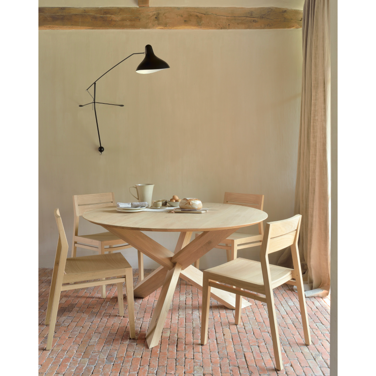 Featuring Oak Circle Round Dining Table by Ethnicraft at Amethyst Home. This Oak Circle Round Dining Table is all about inspiring your family to spend a little more time at the table. The solid legs intertwine in perfect balance to create a unique, bright look to any kitchen or dining area. 
Material: Oak, 100% Solid WoodFinish: Varnished
Dimensions 54": 54"w.  Amethyst Home provides interior design, new home construction design consulting, vintage area rugs, and lighting in the Austin metro area.