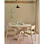 Featuring Oak Circle Round Dining Table by Ethnicraft at Amethyst Home. This Oak Circle Round Dining Table is all about inspiring your family to spend a little more time at the table. The solid legs intertwine in perfect balance to create a unique, bright look to any kitchen or dining area. 
Material: Oak, 100% Solid WoodFinish: Varnished
Dimensions 54": 54"w.  Amethyst Home provides interior design, new home construction design consulting, vintage area rugs, and lighting in the Austin metro area.