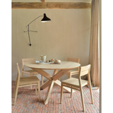 Featuring Oak Circle Round Dining Table by Ethnicraft at Amethyst Home. This Oak Circle Round Dining Table is all about inspiring your family to spend a little more time at the table. The solid legs intertwine in perfect balance to create a unique, bright look to any kitchen or dining area. 
Material: Oak, 100% Solid WoodFinish: Varnished
Dimensions 54": 54"w.  Amethyst Home provides interior design, new home construction design consulting, vintage area rugs, and lighting in the Austin metro area.
