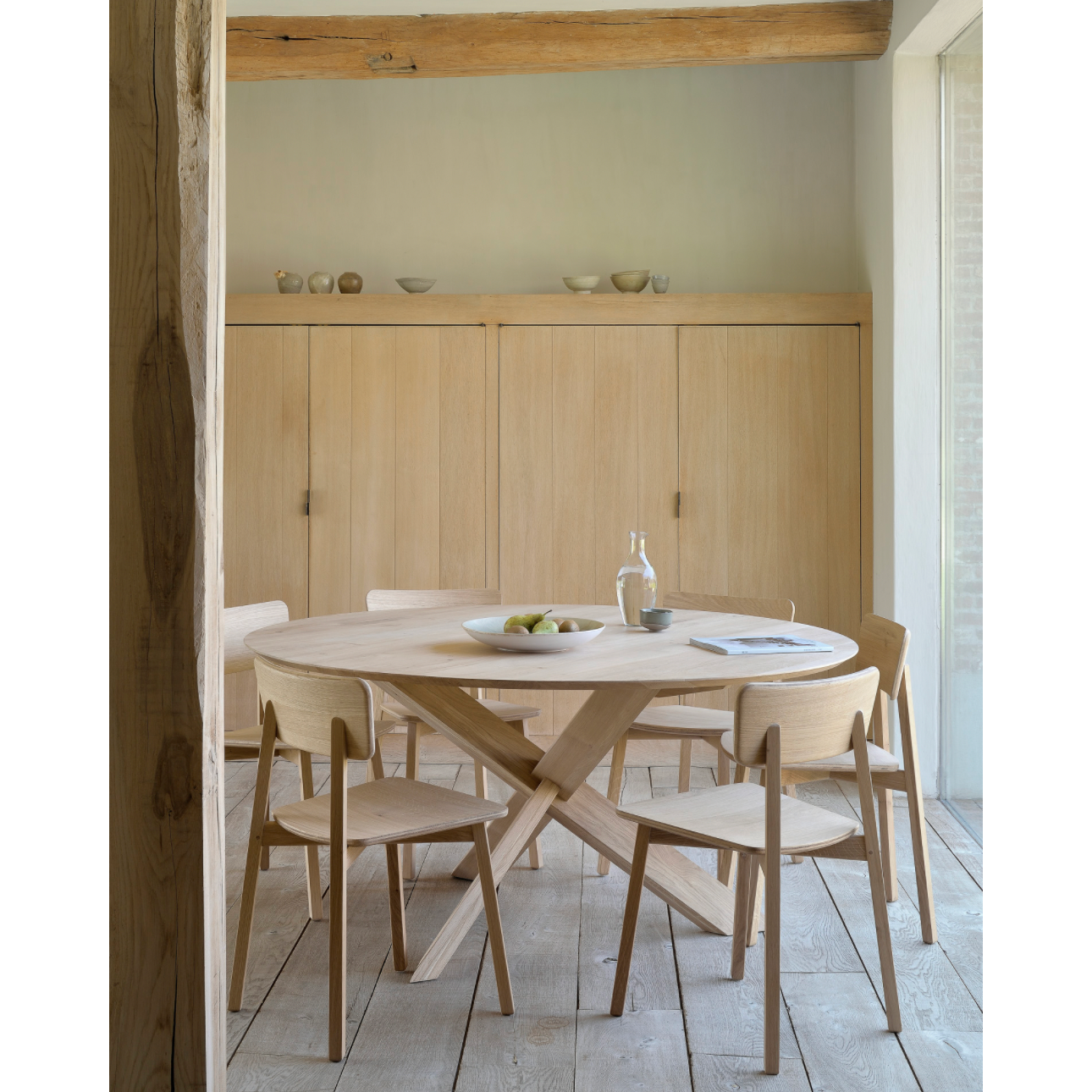 Featuring Oak Circle Round Dining Table by Ethnicraft at Amethyst Home. This Oak Circle Round Dining Table is all about inspiring your family to spend a little more time at the table. The solid legs intertwine in perfect balance to create a unique, bright look to any kitchen or dining area. 
Material: Oak, 100% Solid WoodFinish: Varnished
Dimensions 54": 54"w.  Amethyst Home provides interior design, new home construction design consulting, vintage area rugs, and lighting in the Austin metro area.