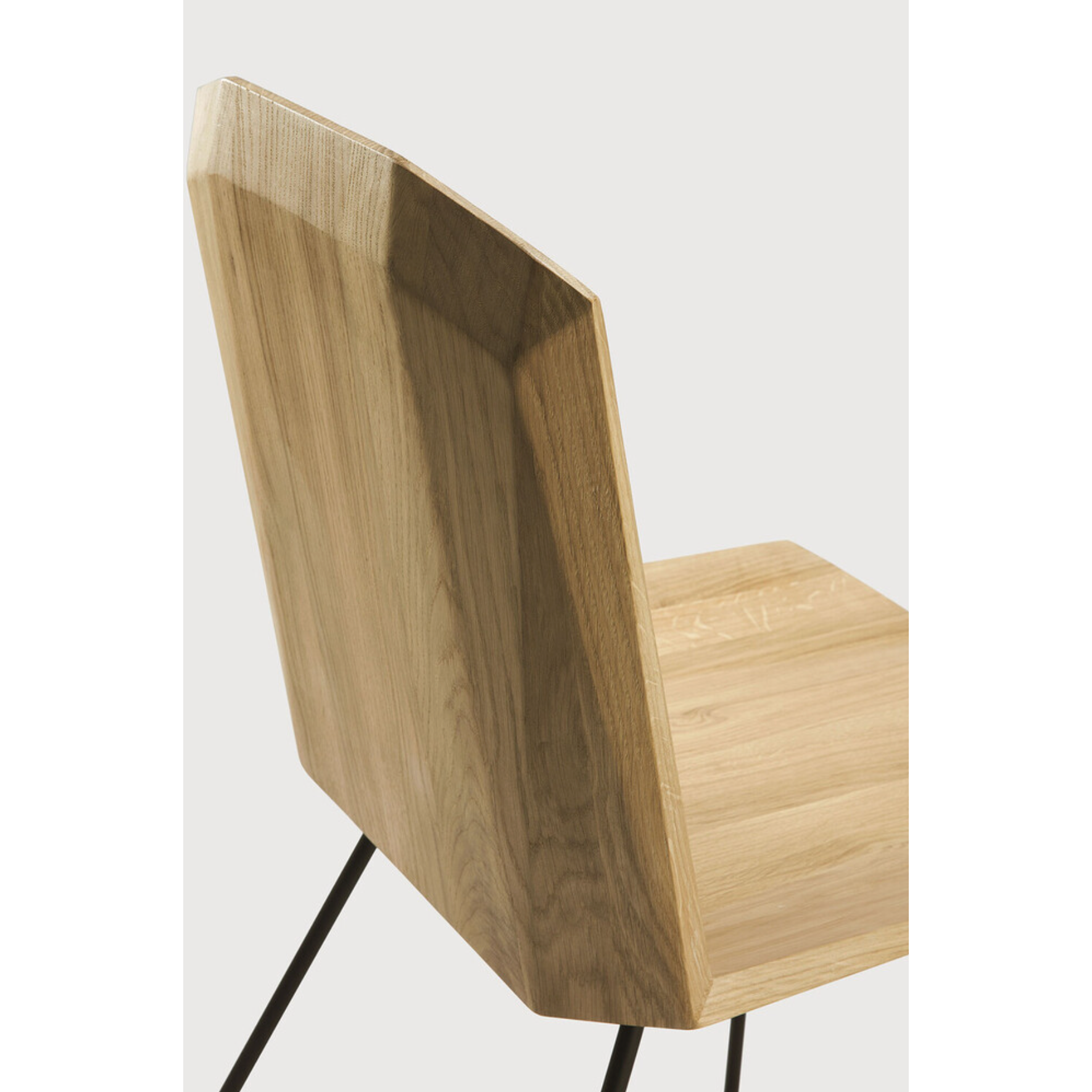 Featuring Oak Facette Dining Chair by Ethnicraft at Amethyst Home. This Oak Facette Dining Chair is both timeless, yet reflecting. We are so intrigued by this chair's ingenious wooden structure that is divided into facets, which makes the seating more comfortable and unique. This beautiful chair will add a sculptural element to your dining table or kitchen.  Amethyst Home provides interior design, new home construction design consulting, vintage area rugs, and lighting in the San Diego metro area.