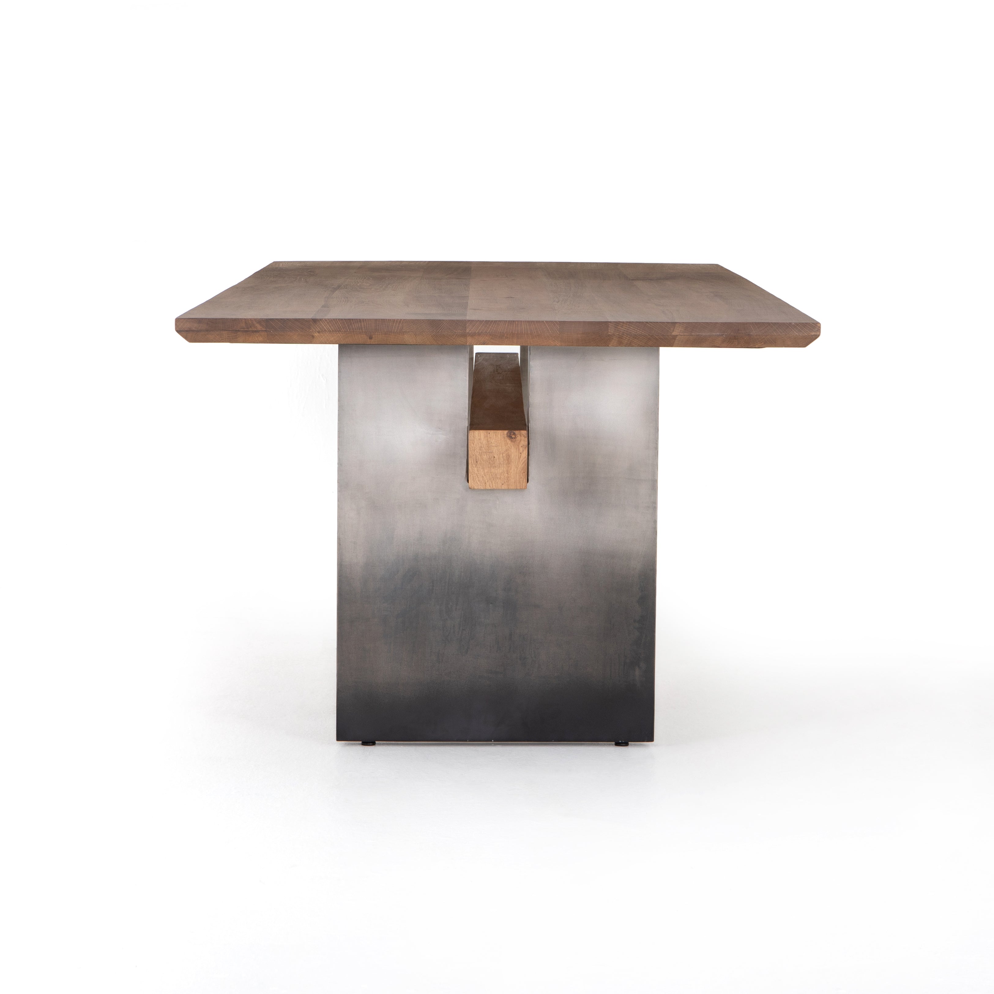 Featuring Brennan Dining Table - Dove Oak by Four Hands at Amethyst Home. This Brennan Dining Table - Dove Oak has a rectangular soft-grey oak tabletop and flaunts its materials' natural graining, for a richly organic takeaway. Wide, plank-style legs of pewter-finished steel features an ombre pattern -- a statement piece for any dining room or kitchen area.  Amethyst Home provides interior design, new home construction design consulting, vintage area rugs, and lighting in the Charlotte metro area.