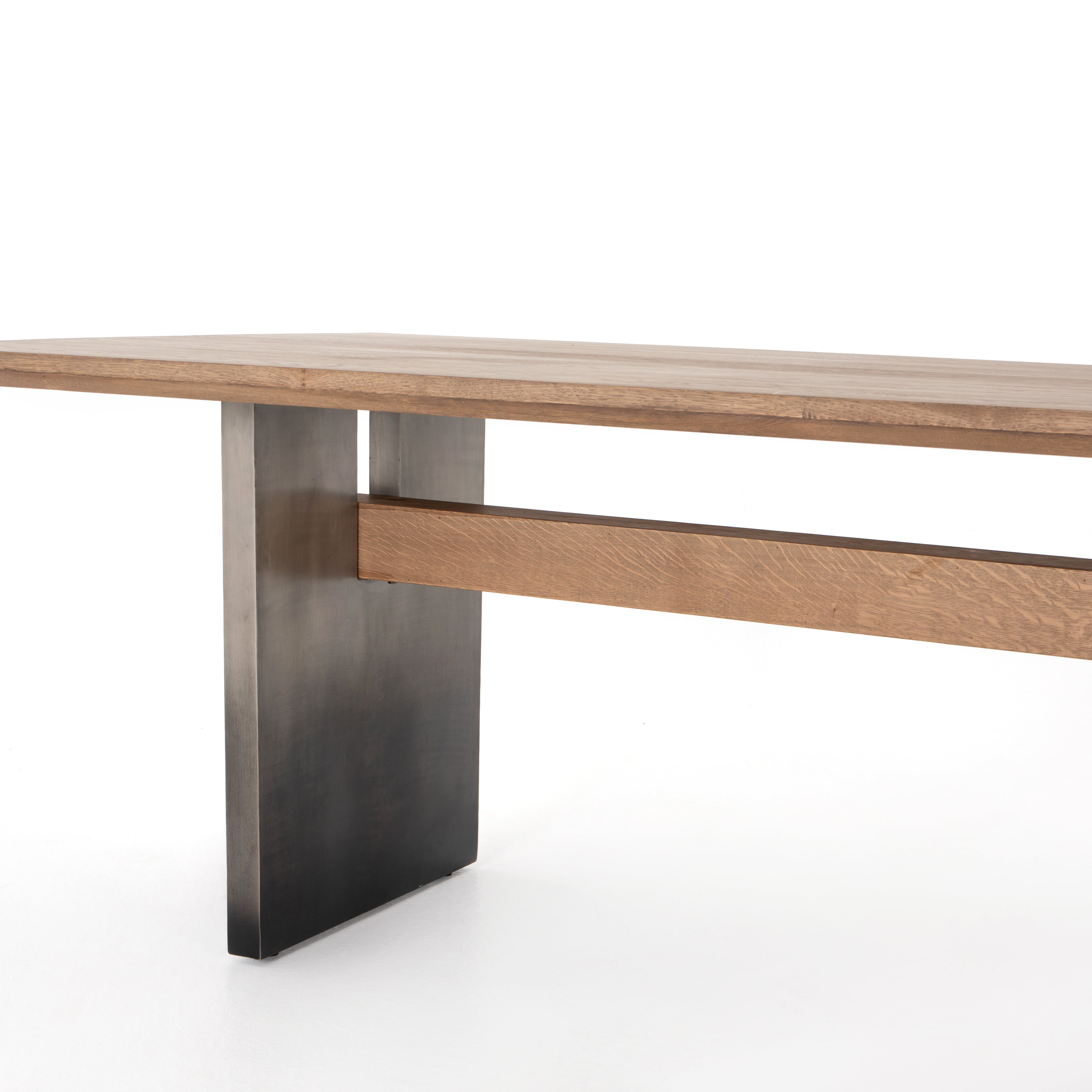 Featuring Brennan Dining Table - Dove Oak by Four Hands at Amethyst Home. This Brennan Dining Table - Dove Oak has a rectangular soft-grey oak tabletop and flaunts its materials' natural graining, for a richly organic takeaway. Wide, plank-style legs of pewter-finished steel features an ombre pattern -- a statement piece for any dining room or kitchen area..  Amethyst Home provides interior design, new home construction design consulting, vintage area rugs, and lighting in the Portland metro area.