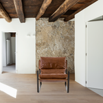 Featuring Emmett Sling Chair - Leather by Four Hands at Amethyst Home. Super stylish, effortlessly cool. Sling-style seating of tobacco-toned leather sits low and curved for a fresh take on a throwback form. Slim, gunmetal-finished iron framing ups the drama factor of an innately hip design.
Overall Dimensions: 29"W x 36"L x 29"HColors: Dakota Tobacco, Gun.  Amethyst Home provides interior design, new home construction design consulting, vintage area rugs, and lighting in the Park City metro area.