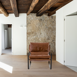 Featuring Emmett Sling Chair - Leather by Four Hands at Amethyst Home. Super stylish, effortlessly cool. Sling-style seating of tobacco-toned leather sits low and curved for a fresh take on a throwback form. Slim, gunmetal-finished iron framing ups the drama factor of an innately hip design.
Overall Dimensions: 29"W x 36"L x 29"HColors: Dakota Tobacco, Gun.  Amethyst Home provides interior design, new home construction design consulting, vintage area rugs, and lighting in the Park City metro area.