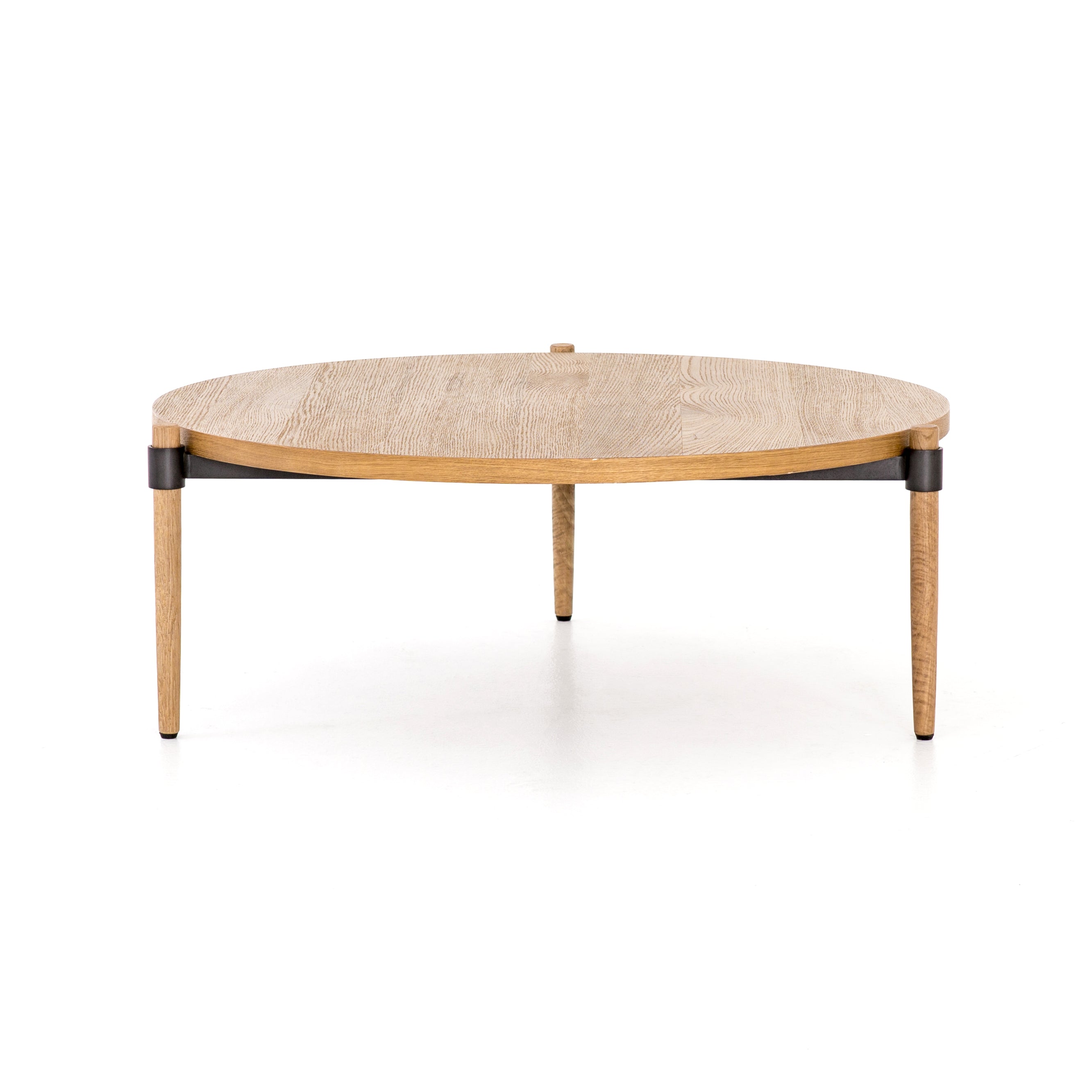 Featuring Holmes Coffee Table by Four Hands at Amethyst Home. Stunning simplicity with a Danish-inspired spin. A rounded tabletop of smoked drift oak offsets a triad of slim, tapered legs. Waxed black joinery adds a fresh look of high contrast. Pair with matching cocktail table for a nested, layered look.
Overall Dimensions: 43"W x 43"L x 14.75"H
Colors: .  Amethyst Home provides interior design, new home construction design consulting, vintage area rugs, and lighting in the Alpharetta metro area.
