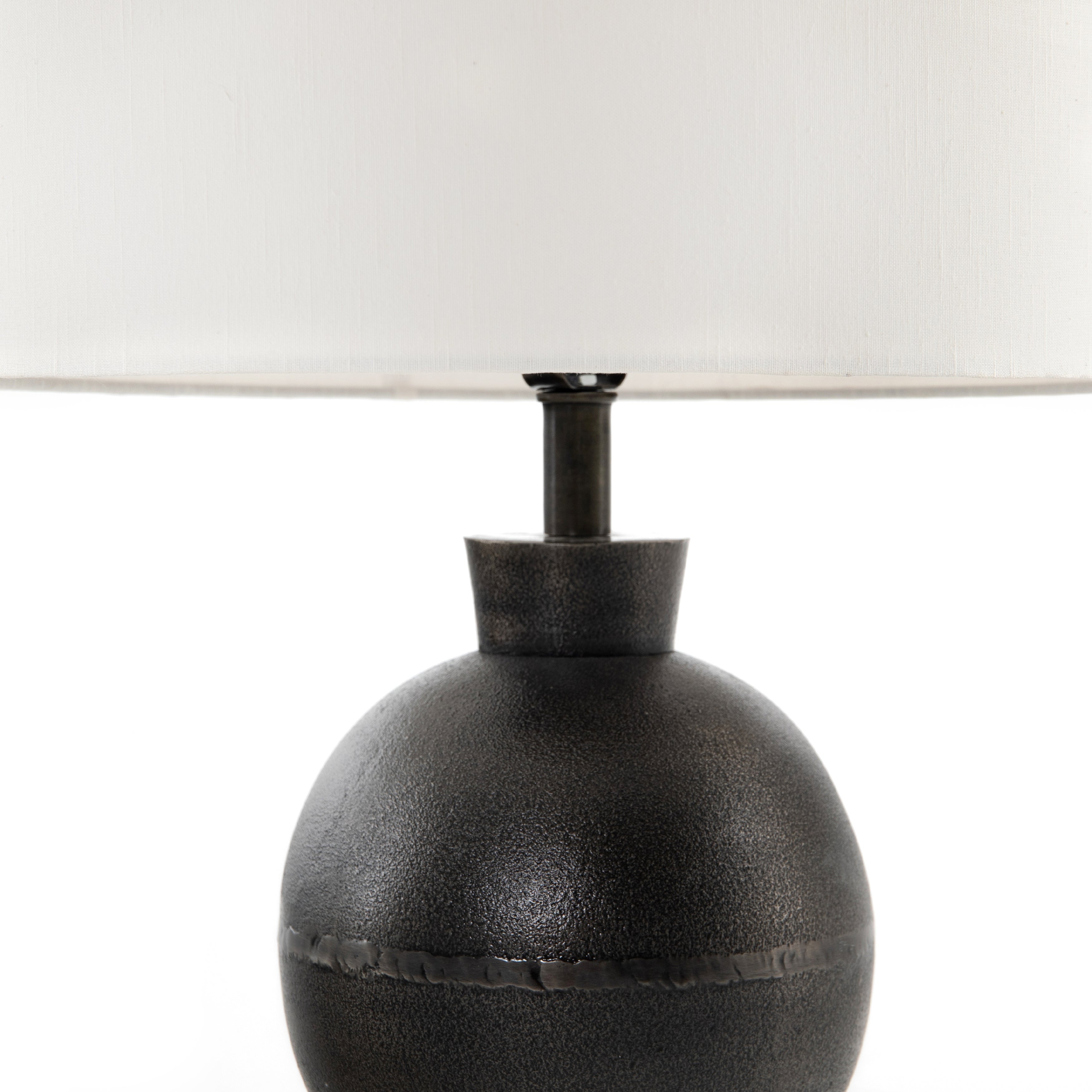 Featuring Kelita Textured Black Table Lamp by Four Hands at Amethyst Home. Textured black aluminum forms a shapely base to beautifully complement a white silk shade with this Kelita Textured Black Table Lamp. A beautiful lamp to place next your bed, sofa, or other area needing extra light.
Overall Dimensions: 16"W x 16"L x 25"H
Colors: Textured Black Alum.  Amethyst Home provides interior design, new home construction design consulting, vintage area rugs, and lighting in the Washington metro area.