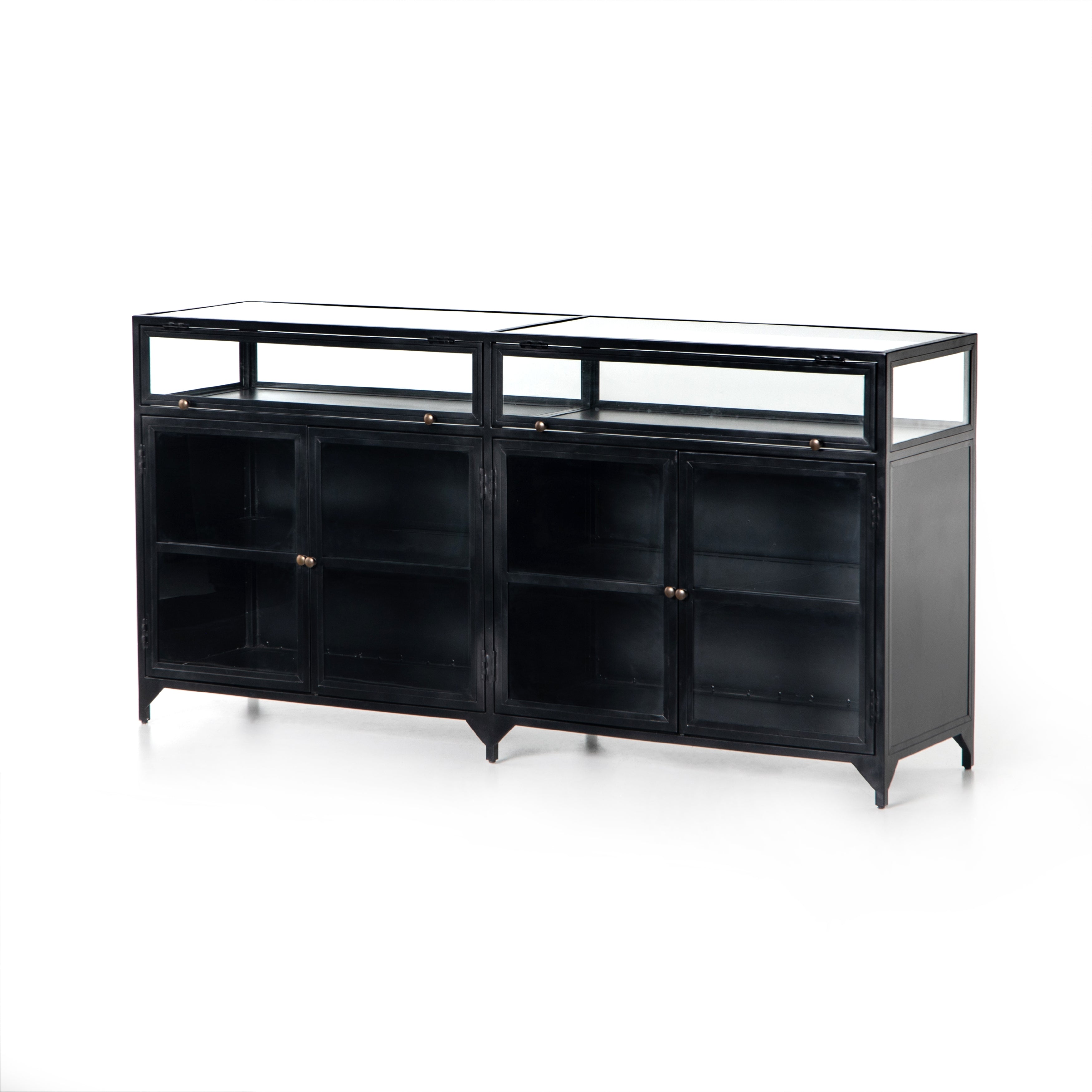 Featuring Shadow Box Sideboard - Black by Four Hands at Amethyst Home. This Shadow Box Sideboard gives your inner collector a place to play. Store prized possessions behind clear glass fronts, with black-finished metal casing and brass hardware for contrast.
Overall Dimensions: 70"W x 17.25"L x 35"H
Colors: Black, Weathered Bronze, Clear Glass, Tempere.  Amethyst Home provides interior design, new home construction design consulting, vintage area rugs, and lighting in the Newport Beach metro area.