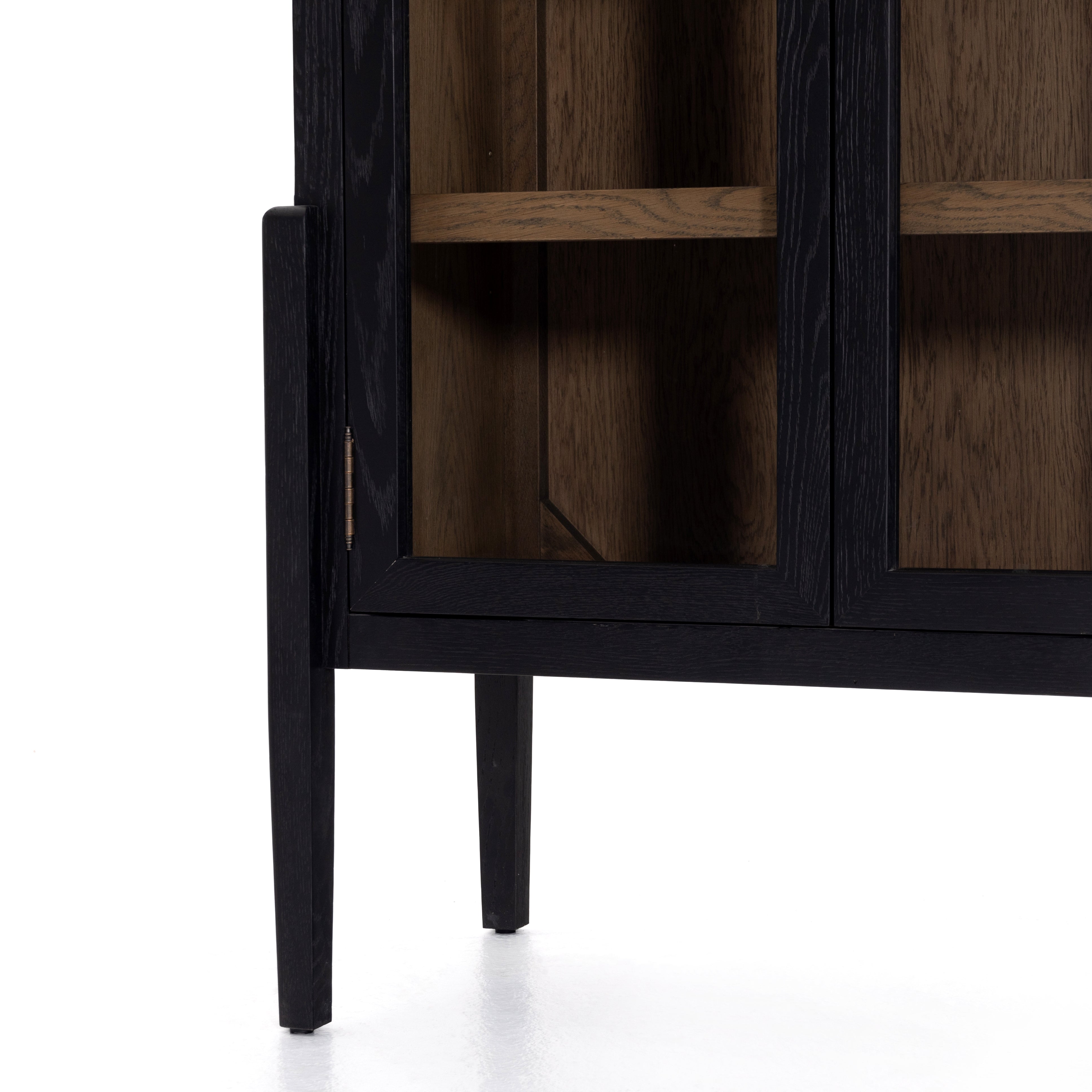 Featuring Tolle Cabinet - Drifted Matte Black by Four Hands at Amethyst Home. The original and signature two tone solid oak cabinet! Carefully crafted on stiletto legs, our clients enjoy its stunning wood grain look.
Overall Dimensions: 38"W x 19"L x 84"HColors: Antique Brass, Drifted Black, Drifted Oak SolidMaterials: Iron, Solid OakWeight: 185.3 lbVolume.  Amethyst Home provides interior design, new home construction design consulting, vintage area rugs, and lighting in the Charlotte metro area.