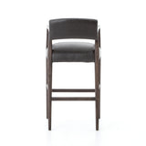 Featuring Tyler Chaps Ebony Counter Stool by Four Hands at Amethyst Home. The Tyler Counter Stool in Chaps Ebony makes counter seating stylish with an angular, dark and smoky birch frame, a deep seat, and a striking, low-slung back. The stool is comfortable for long dinners and conversations with a covered black, top-grain leather seat and back.
Counte.  Amethyst Home provides interior design, new home construction design consulting, vintage area rugs, and lighting in the Newport Beach metro area.