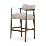 Featuring Waldon Counter Stool by Four Hands at Amethyst Home. Slim, sculptural style with this Waldon Counter Stool. Angular framing features a mix of bronze-finished metal and solid rubberwood, for a forward-thinking feel. Textural linen-blend seating adopts an invitingly neutral grey hue to move freely between spaces and styles.
Size: 23.25"W x 24.50"L.  Amethyst Home provides interior design, new home construction design consulting, vintage area rugs, and lighting in the Scottsdale metro area.