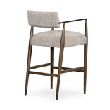Featuring Waldon Counter Stool by Four Hands at Amethyst Home. Slim, sculptural style with this Waldon Counter Stool. Angular framing features a mix of bronze-finished metal and solid rubberwood, for a forward-thinking feel. Textural linen-blend seating adopts an invitingly neutral grey hue to move freely between spaces and styles.
Size: 23.25"W x 24.50"L x 3.  Amethyst Home provides interior design, new home construction design consulting, vintage area rugs, and lighting in the Austin metro area.