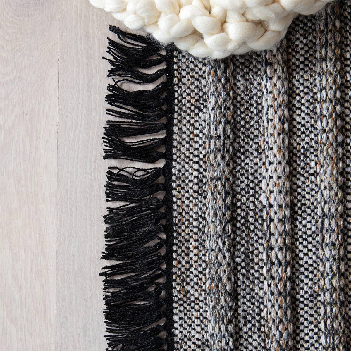 Featuring Castillo Torre Rug - Jet Black by Jaipur Living at Amethyst Home. The handwoven Castillo Torre Area Rug - Jet Black features a soft feel and relaxed, versatile style. The Torre area rug showcases a rich blend of black, gray, and rust tan tones for a grounding, neutral look. Crafted of PET yarn, or recycled plastic, this durable and textured rug b.  Amethyst Home provides interior design, new home construction design consulting, vintage area rugs, and lighting in the Nashville metro area.