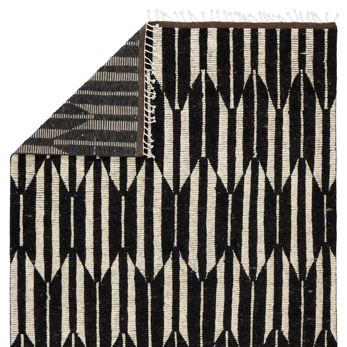 Featuring Keoka Quest Mole Hand-Knotted Rug by Jaipur Living at Amethyst Home. The Keoka Quest Mole Area Rug boasts a fresh take on classic Afghani hand-knotted textiles. In rich, grounding tones of deep brown and ivory, the stylish contrast of the Quest rug anchors room with bold yet neutral appeal. The texture-rich wool pile features a ribbed construction th.  Amethyst Home provides interior design, new home construction design consulting, vintage area rugs, and lighting in the Tampa metro area.