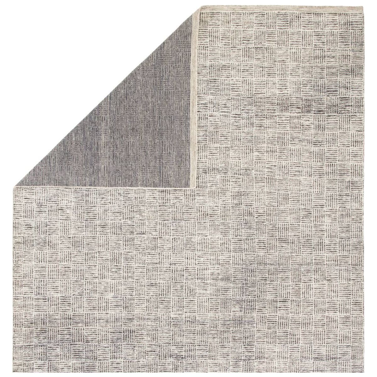 Featuring Rize Mugler Hand-Knotted Rug by Jaipur Living at Amethyst Home. The Rize Mugler Area Rug offers intricate and delicately designed global patterns to the modern home. A thatched square motif creates an eye-catching geometric design on the artistically distressed Mugler area rug. In an earthy ivory and black colorway, this durable hand-knotted wool acc.  Amethyst Home provides interior design, new home construction design consulting, vintage area rugs, and lighting in the Tampa metro area.