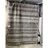 Featuring Iman Ivory/Charcoal Hand-Knotted Rug by Loloi at Amethyst Home. A new take on Moroccan style rugs, the Iman Collection is hand-knotted of 100% wool pile by skilled artisans in India. The surface features linear and braided details, creating tonal variations that make each piece unique. Plus, each design is finished with playful fringe.
Hand Knot.  Amethyst Home provides interior design, new home construction design consulting, vintage area rugs, and lighting in the Des Moines metro area.