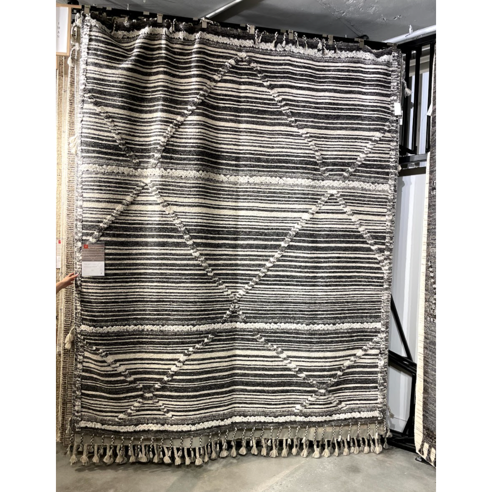 Featuring Iman Ivory/Charcoal Hand-Knotted Rug by Loloi at Amethyst Home. A new take on Moroccan style rugs, the Iman Collection is hand-knotted of 100% wool pile by skilled artisans in India. The surface features linear and braided details, creating tonal variations that make each piece unique. Plus, each design is finished with playful fringe.
Hand Knot.  Amethyst Home provides interior design, new home construction design consulting, vintage area rugs, and lighting in the Des Moines metro area.