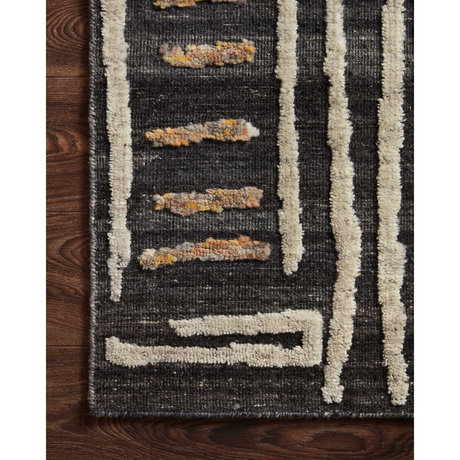 The Naomi Charcoal / Natural Area Rug is hand-knotted of wool and cotton by artisans in India. Naomi offers bold designs with earthy hues and features a high-low pile that adds depth and dimension, making each piece create the illusion of movement. A perfect rug for your living room, entryway, or other Hand Knotted 89% Wool | 11% Cotton NAO-05 Charcoal/Natural