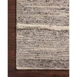Hand-woven of 100% wool in India, the Loloi Rayan Charcoal / Ivory Area Rug, or RAY-03, sets the tone for a calming atmosphere. Each design is crafted of textural highs and lows paired with neutral tones to create and engaging understatement. The perfect rug for your bedroom, office, or other medium traffic area.