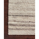 Hand-woven of 100% wool in India, the Loloi Rayan Natural / Grey Area Rug, or RAY-04, sets the tone for a calming atmosphere. Each design is crafted of textural highs and lows paired with neutral tones to create and engaging understatement. The perfect rug for your bedroom, office, or other medium traffic area.
