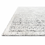 Hand-knotted in India of viscose and cotton, the Vestige White / Black Area Rug recalls ancient khotan rugs in an updated color palette. Soft underfoot, the silken yarns temper the graphic motifs to create a versatile foundation. Hand Knotted 89% Viscose | 11% Cotton VQ-01 White / Black