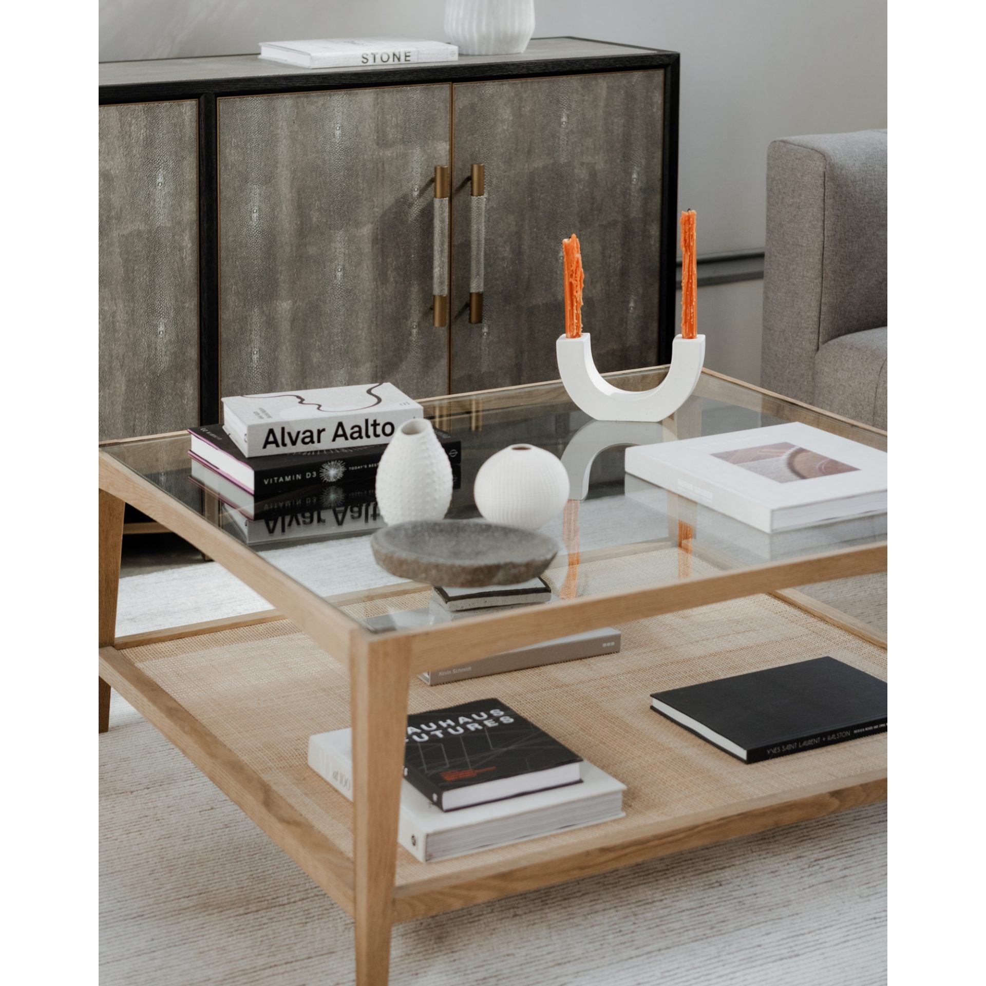 Both functional and beautiful, this Harrington Coffee Table features a natural cane shelf, perfect for storing your favorite books, magazines, or other accessories!   Dimensions: 39.5"W x 39.5"D x 16.5"H Materials:  Solid Oak Frame, Tempered Glass Top, Natural Cane Shelf