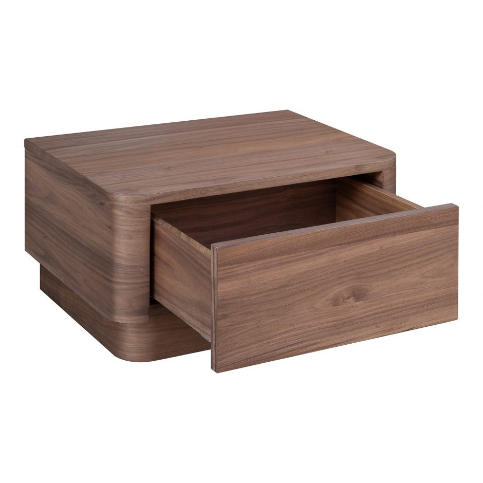 We love the soft, rounded edges of this Round Off Nightstand - Walnut. With a pull out drawer, this is both a functional and beautiful piece to add to any bedroom or guest room!   Size: 20 x 15"D x 11"H Material: Walnut Veneer, MDF, Rubberwood Base