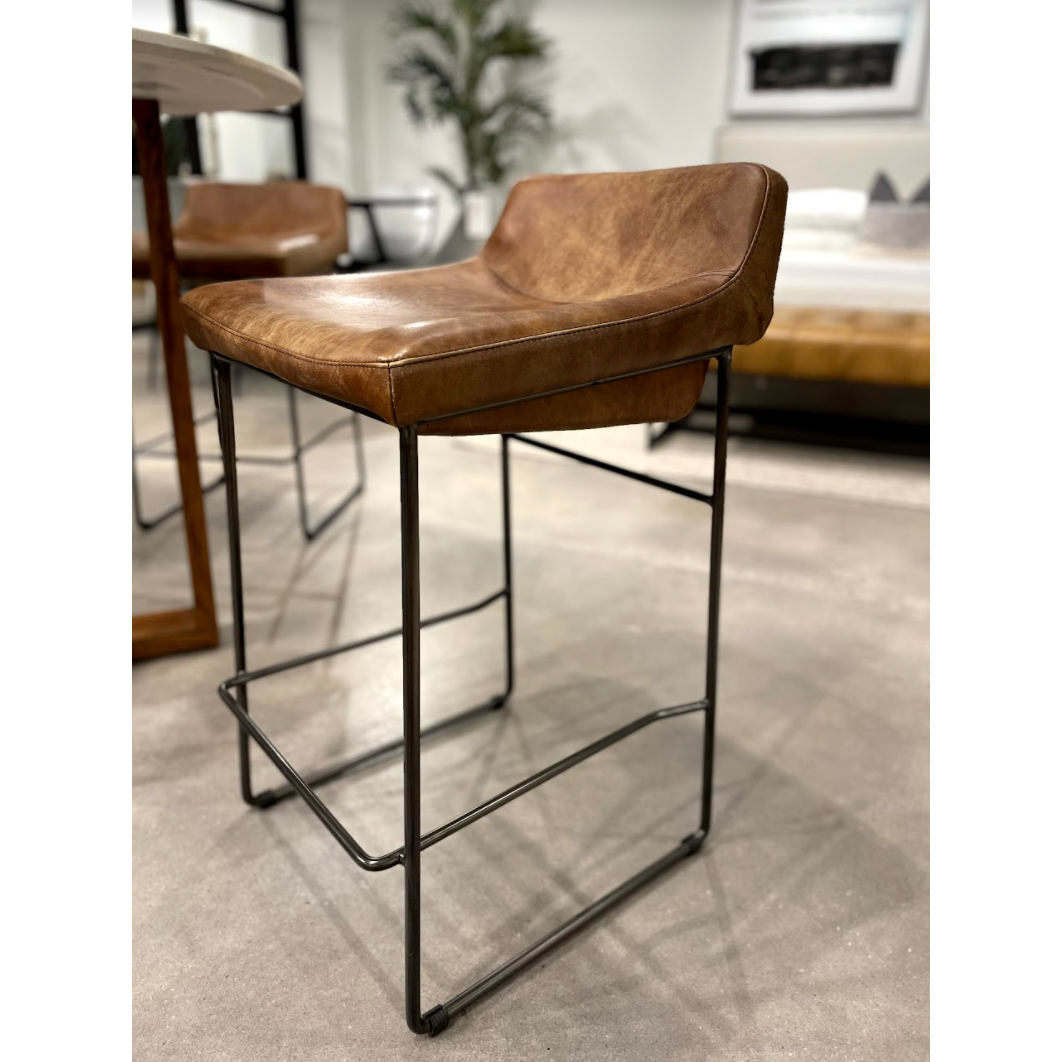 Upgrade your kitchen or dining room with this sleek, cocktail-ready Starlet Counter + Bar Stool - Open Road Brown Leather that showcases poise and comfort. This adds a cool sophistication to your space with its slim iron frame and luxe leather upholstery.