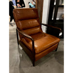 A sleek seat with hidden push-back reclining functionality. This midcentury-inspired recliner features wide chunky channeling paired with slim paddle arms and a tapered wood frame. Designed with a high seat and high back for extra comfy support. Upholstered in a timeless tobacco-hued leather made in a family-owned tannery in Thailand. Amethyst Home provides interior design, new home construction design consulting, vintage area rugs, and lighting in the Alpharetta metro area.