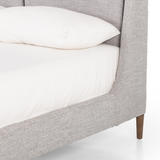 Light, livable luxury. Upholstered in a grey synthetic-blend, a tapered headboard features fixed overscale pillows, for a calming look with great depth. Wire-brushed parawood legs lend a warm, natural finishing touch. Performance fabrics are specially created to withstand spills, stains, high traffic and wear, ensuring long-term comfort and unmatched durability. Amethyst Home provides interior design, new home construction design consulting, vintage area rugs, and lighting in the Laguna Beach metro area.