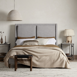 Light, livable luxury. Upholstered in a grey synthetic-blend, a tapered headboard features fixed overscale pillows, for a calming look with great depth. Wire-brushed parawood legs lend a warm, natural finishing touch. Performance fabrics are specially created to withstand spills, stains, high traffic and wear, ensuring long-term comfort and unmatched durability. Amethyst Home provides interior design, new home construction design consulting, vintage area rugs, and lighting in the Monterey metro area.