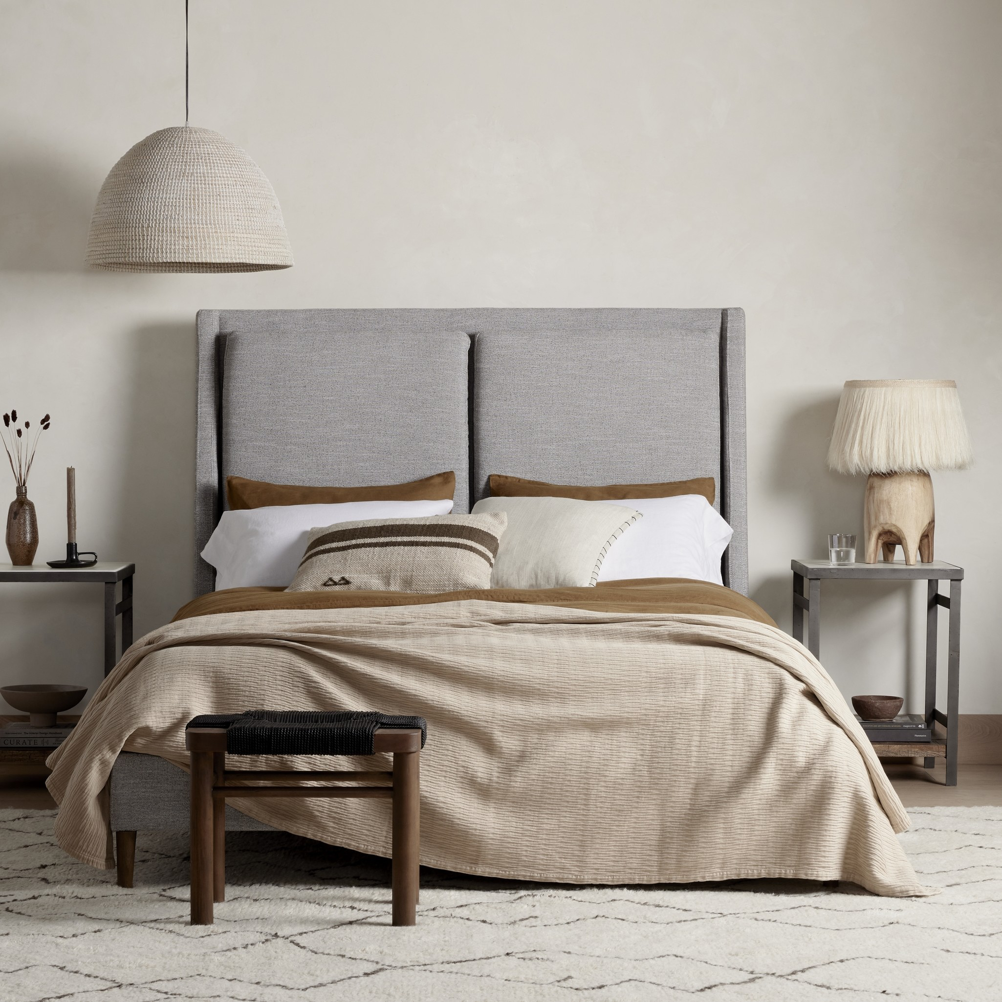 Light, livable luxury. Upholstered in a grey synthetic-blend, a tapered headboard features fixed overscale pillows, for a calming look with great depth. Wire-brushed parawood legs lend a warm, natural finishing touch. Performance fabrics are specially created to withstand spills, stains, high traffic and wear, ensuring long-term comfort and unmatched durability. Amethyst Home provides interior design, new home construction design consulting, vintage area rugs, and lighting in the Monterey metro area.