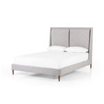 Light, livable luxury. Upholstered in a grey synthetic-blend, a tapered headboard features fixed overscale pillows, for a calming look with great depth. Wire-brushed parawood legs lend a warm, natural finishing touch. Performance fabrics are specially created to withstand spills, stains, high traffic and wear, ensuring long-term comfort and unmatched durability. Amethyst Home provides interior design, new home construction design consulting, vintage area rugs, and lighting in the Dallas metro area.