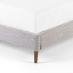 Light, livable luxury. Upholstered in a grey synthetic-blend, a tapered headboard features fixed overscale pillows, for a calming look with great depth. Wire-brushed parawood legs lend a warm, natural finishing touch. Performance fabrics are specially created to withstand spills, stains, high traffic and wear, ensuring long-term comfort and unmatched durability. Amethyst Home provides interior design, new home construction design consulting, vintage area rugs, and lighting in the Tampa metro area.