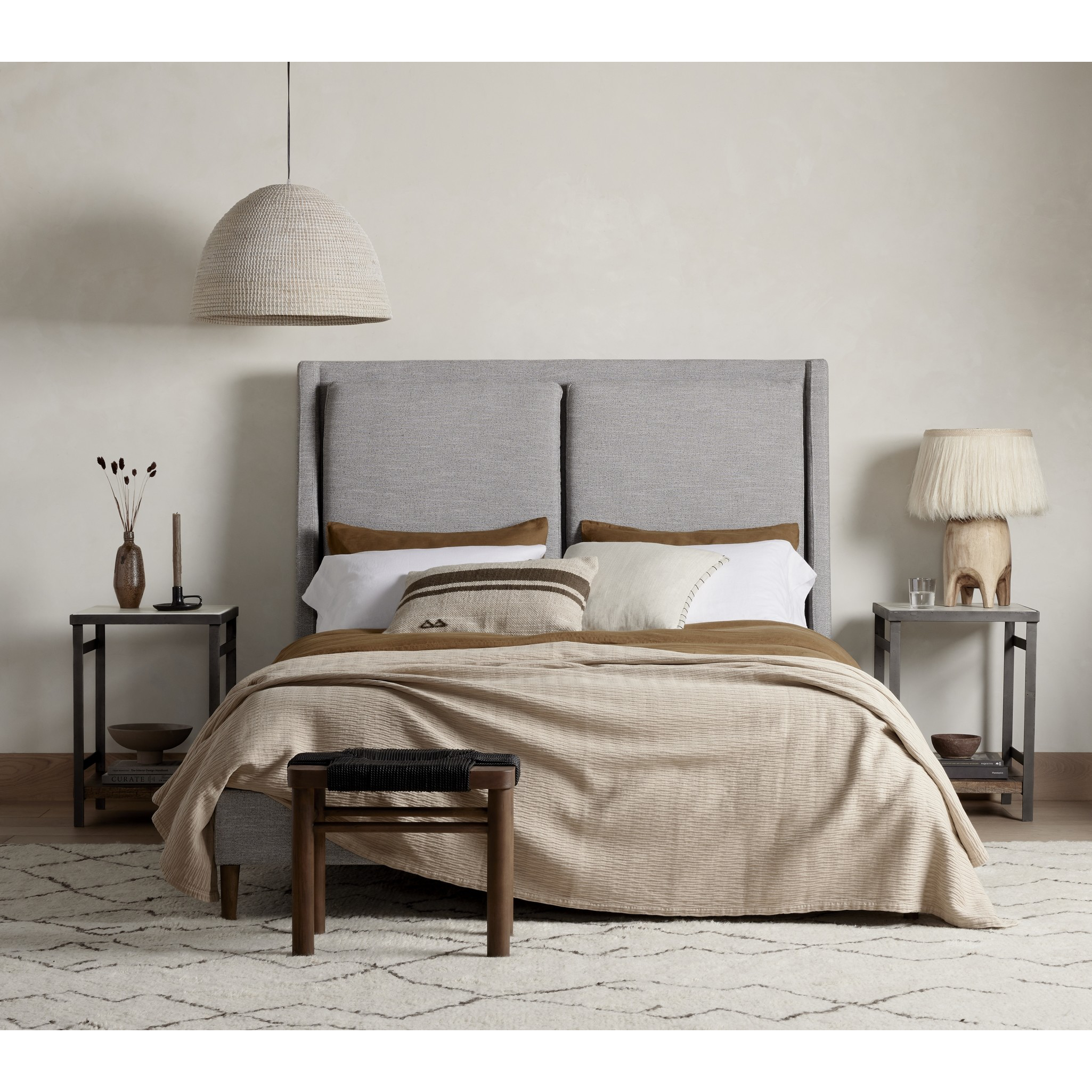 Light, livable luxury. Upholstered in a grey synthetic-blend, a tapered headboard features fixed overscale pillows, for a calming look with great depth. Wire-brushed parawood legs lend a warm, natural finishing touch. Performance fabrics are specially created to withstand spills, stains, high traffic and wear, ensuring long-term comfort and unmatched durability. Amethyst Home provides interior design, new home construction design consulting, vintage area rugs, and lighting in the Park City metro area.