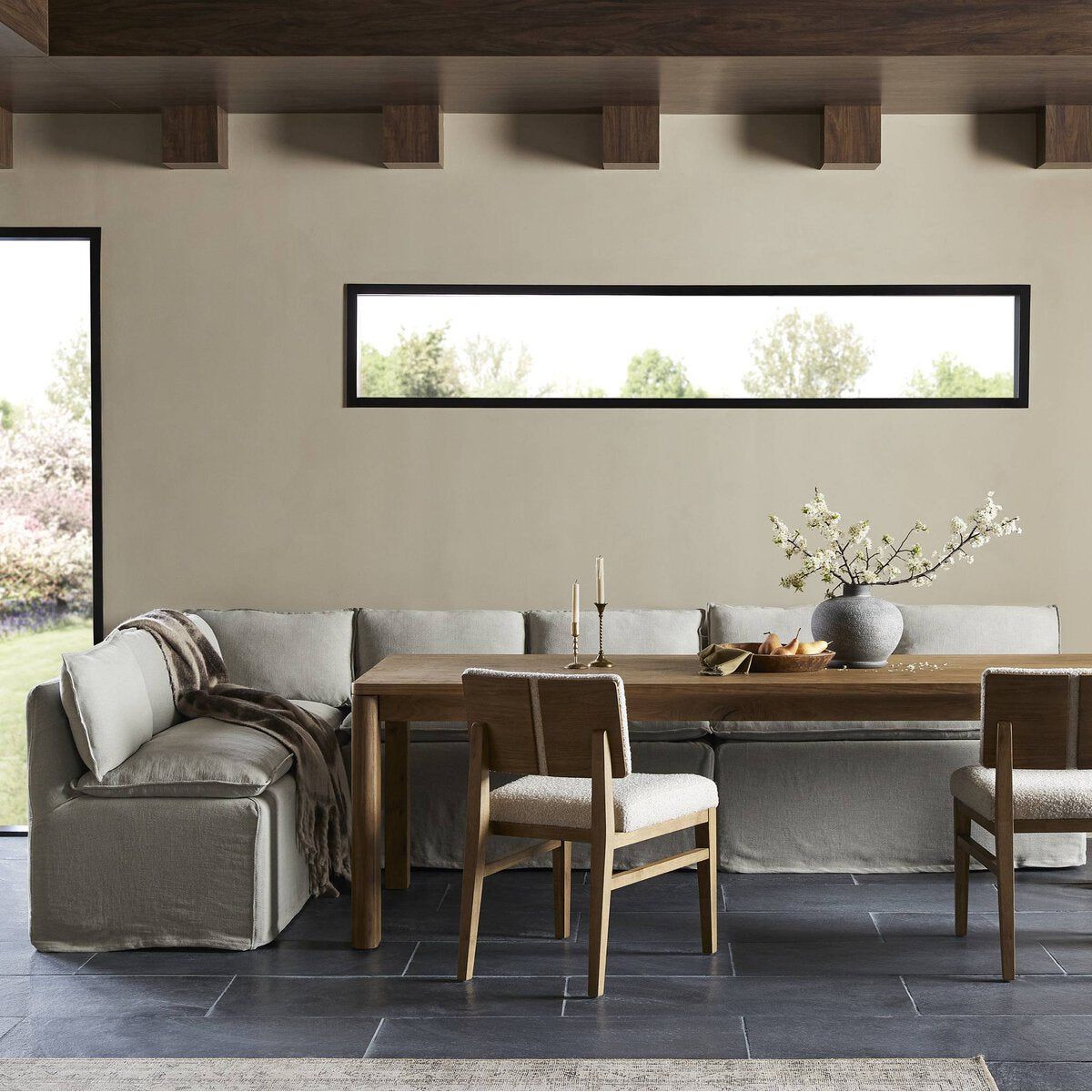 Featuring Andre Slipcovered Linen Dining Banquette Corner by Four Hands at Amethyst Home. This Andre Broadway Stone Slipcover Dining Corner Piece is the perfect solution for your dining needs. With its versatile design and comfortable sofa feature, it offers both style and functionality. Made with quality materials, it provides durability and long-lasti. Amethyst Home provides interior design, new home construction design consulting, vintage area rugs, and lighting in the Winter Garden metro area.