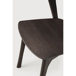 Over the years, the Bok dining chair has become one of our most recognisable designs. Designer Alain van Havre combines sculptural elegance and contemporary crafting into a graceful and airy form.

Seating height: 46cm - 18".
Made from brown tainted oak with a varnish finish. Amethyst Home provides interior design, new construction, custom furniture, and area rugs in the Omaha metro area
