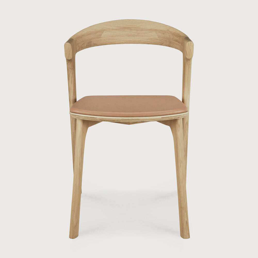 Featuring Bok Sienna Leather Varnished Oak Dining Chair by Ethnicraft at Amethyst Home. Reminiscent of a goat's curved horns, the Bok collection combines sculptural elegance and contemporary crafting into a graceful and airy form. Over the years, the Bok dining chair has become one of Ethnicraft's most recognisable designs.Weight : 15 lbs Dimensions: 21.5" W x 20" L x 30" H. Amethyst Home provides interior design, new construction, custom furniture, and area rugs in the Houston metro area